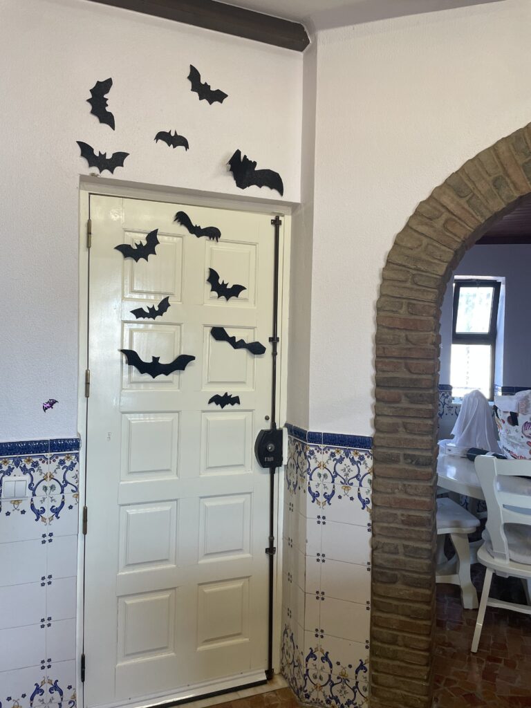 paper bats halloween decor on a door. 